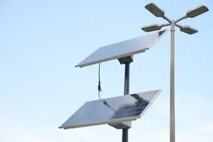 Quad-head solar street light fixture against the sky