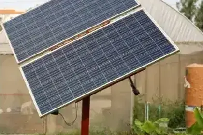 Solar panel array installed near farm greenhouses